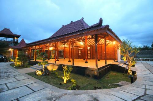 a villa with a pavilion in the night at The Royal Joglo in Tepus