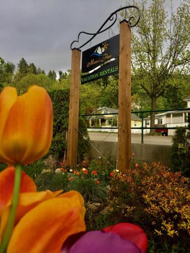 a sign for a school with flowers in front of it at Mistiso's Place Vacation Rentals in Nelson