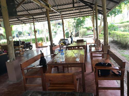 a restaurant with tables and chairs and a motorcycle in the background at Paipunthong Resort in Pai