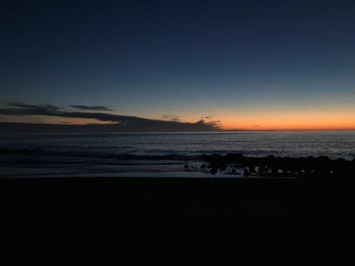 a group of people on the beach at sunset at Il terrazzino di Lulù in Cetraro