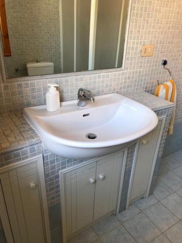 a bathroom with a white sink and a mirror at Il terrazzino di Lulù in Cetraro