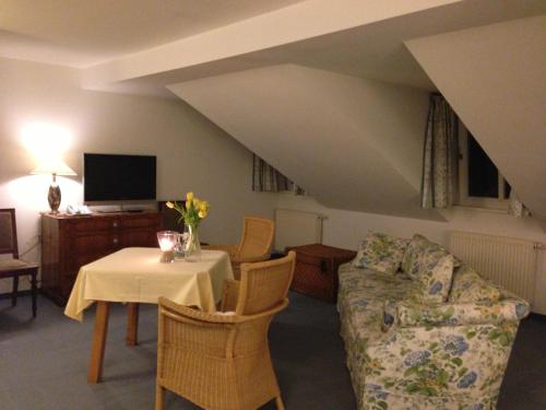 a living room with a table and a couch at Landhaus Lockwitzgrund in Lockwitz