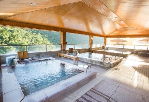 a large swimming pool with two jacuzzi at Dong Tair Spa Hotel in Wenquan