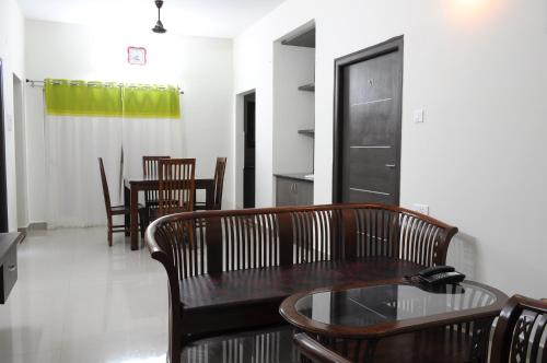 a dining room with a wooden table and chairs at Comfort Stay in Tada