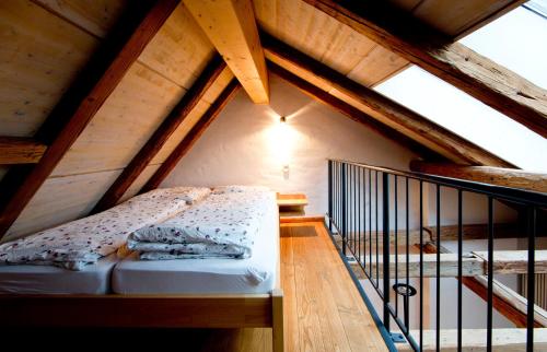 a bedroom in a attic with a bed in it at Bioweingut und Ferienwohnung in Efringen-Kirchen
