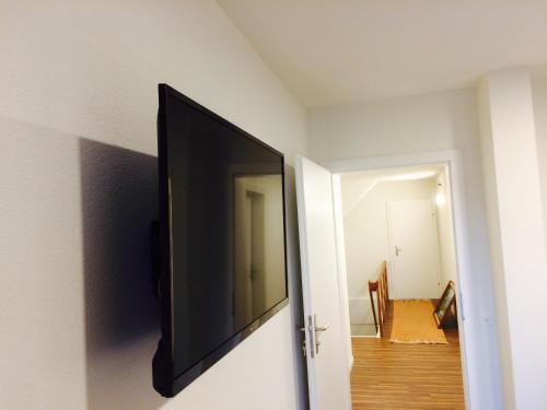 a flat screen tv hanging on a wall in a room at Landgasthof Schwanen in Merenschwand