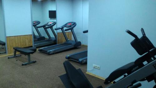 a row of exercise bikes in a gym with mirrors at New Gudauri Sunny studio in Gudauri