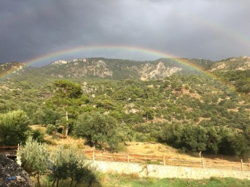 a rainbow in the sky over a mountain at Beso Patara in Patara