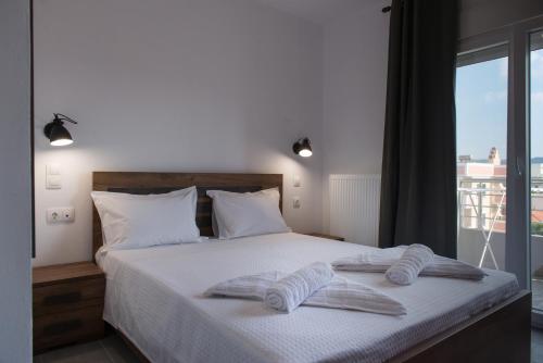 a bedroom with a bed with two towels on it at House Okto in Alexandroupoli