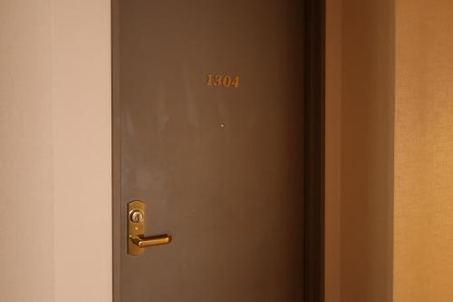 a door with the number written on it at Fukuno Town Hotel A・Mieux in Nanto