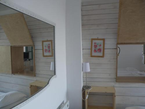a mirror in a room with a bedroom at Spitakia in Vourkari