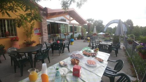 a table with plates of food on a patio at Agriturismo Parco Campofelice in Lombardore