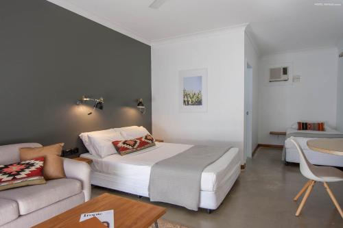 a hotel room with a bed and a couch at Motel Nomad in Cairns