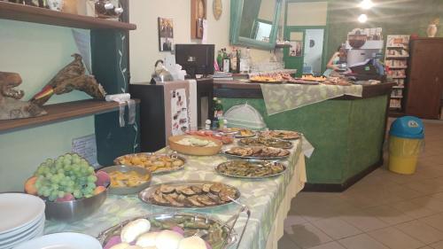 a table with many plates of food on it at Agriturismo Parco Campofelice in Lombardore