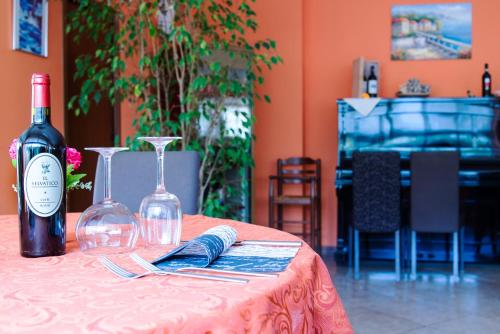 a table with a bottle of wine and a glass at Cavalieri del Tau in Altopascio