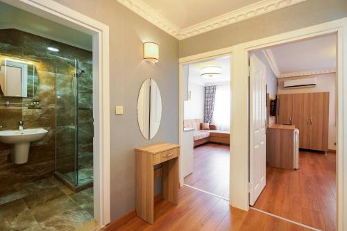 a bathroom with a shower and a sink and a mirror at Authentic Apartments OldCity in Istanbul