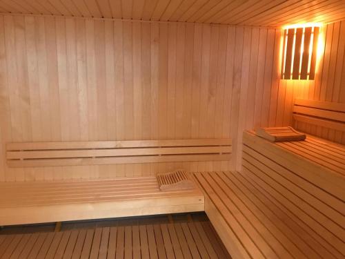 a sauna with a bench in the middle of it at Golf Hôtel in Brides-les-Bains