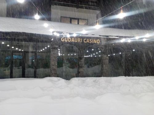 a building with a sign in the snow at New Gudauri Sunny studio in Gudauri
