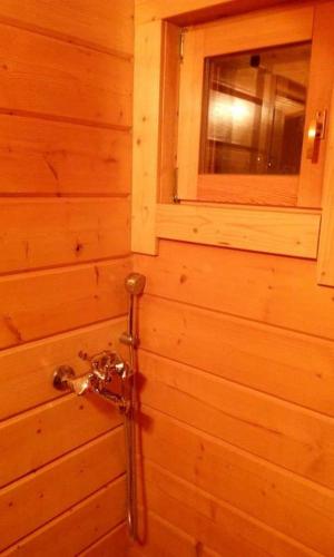 a bathroom with a shower in a wooden wall at Kedra Village in Kédra