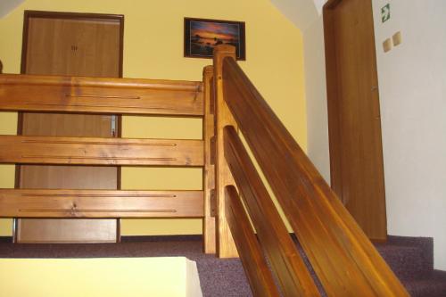 a wooden staircase in a room with a stair case at Penzion Seidl in Rokytnice nad Jizerou