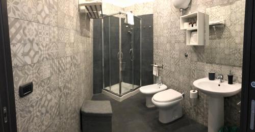 a bathroom with a shower and a toilet and a sink at La Dimora di Garibaldi in Naples