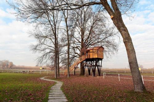 a tree house in the middle of a park at Agriturismo Tenuta "Il Cigno" in Villanterio