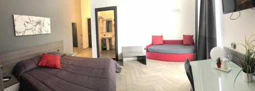 a living room with a couch and a bed at La Dimora di Garibaldi in Naples