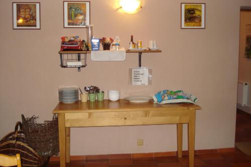 a wooden table with plates on it in a room at Penzion Seidl in Rokytnice nad Jizerou