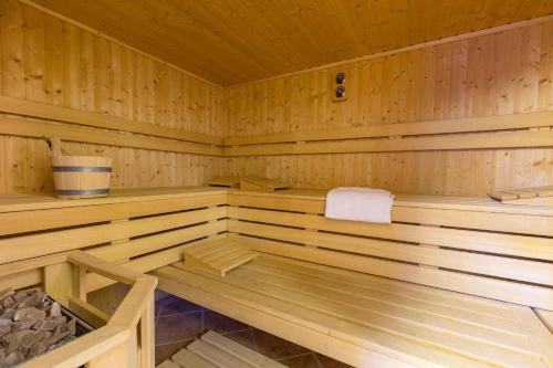 a wooden sauna with a white towel in it at Aparthotel Berlin in Bad Nenndorf