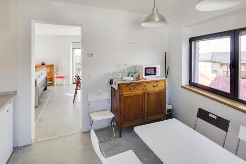 a room with a desk and a table and a window at Casa la Devesa de Sanabria in Remesal
