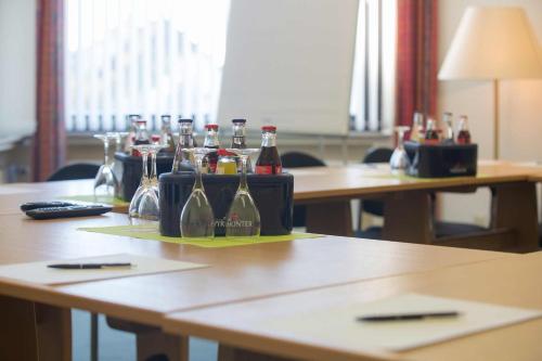 a table with bottles of alcohol and glasses on it at Aparthotel Berlin in Bad Nenndorf