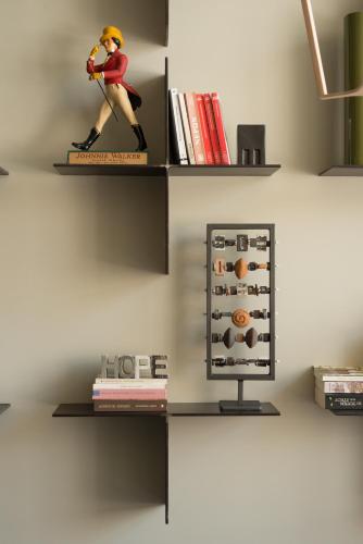 a shelf with a figurine of a person playing a violin at Olympic Hotel in Heraklio Town