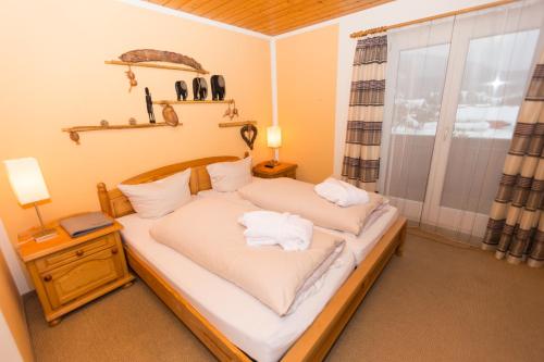 a bedroom with two beds and a window at DEVA Hotel Kaiserblick in Reit im Winkl