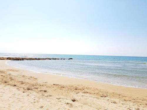 une plage de sable avec l'océan en arrière-plan dans l'établissement VanessaHolidayHome, à Cava dʼAliga