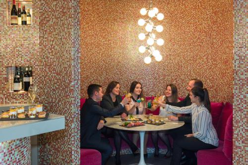 a group of people sitting around a table in a restaurant at Mercure Paris Vaugirard Porte De Versailles in Paris