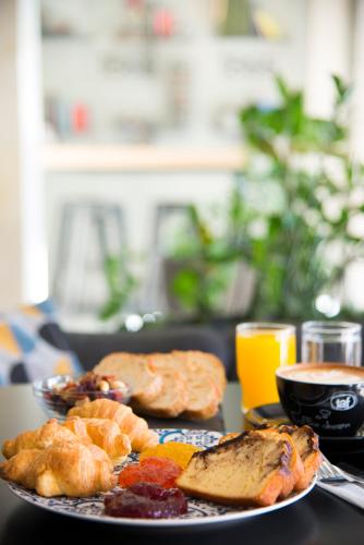 a plate of food on a table with bread and pastries at Olympic Hotel in Heraklio Town