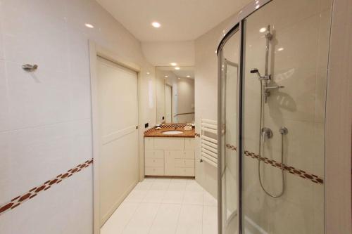 a bathroom with a walk in shower and a sink at Apartment De Rossi in Bari