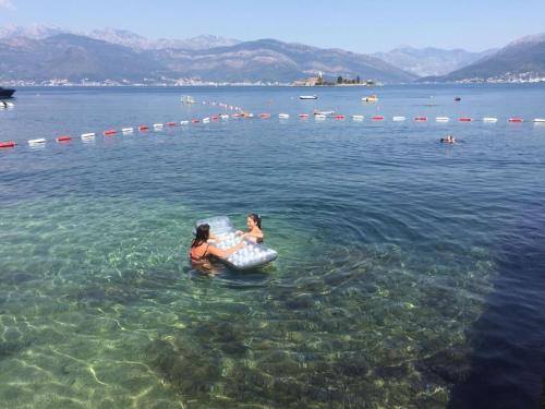 two people in the water in a body of water at Patrick House in Tivat