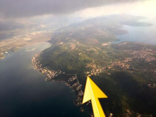 a yellow arrow is flying over a lake at Patrick House in Tivat