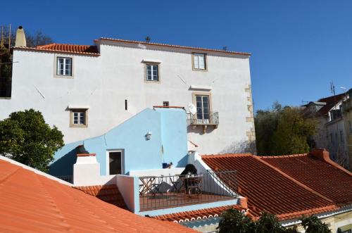a white house with red roofs at Proa d'Alfama Guest House in Lisbon