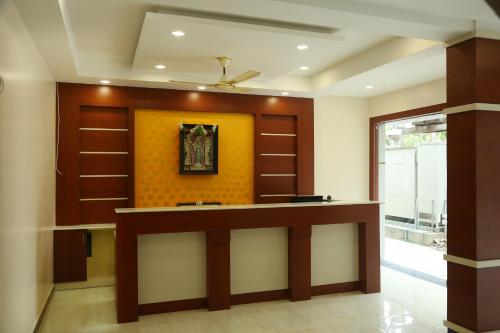 a lobby with a reception desk in a building at Hotel Sabareesh Plaza in Madurai