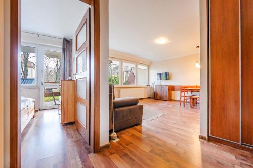 a living room with a couch and a dining room at Promenada I, Sun & Snow in Świnoujście