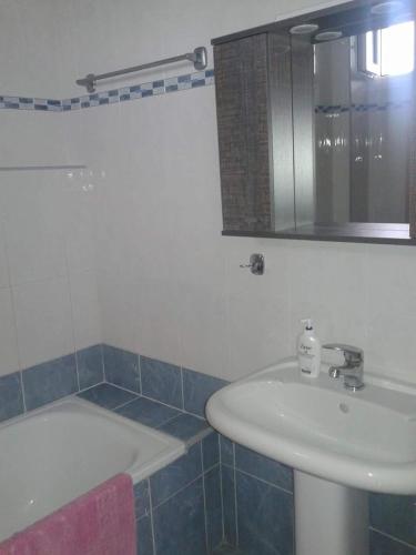 a bathroom with a sink and a bath tub at Villagiannis in Nea Fokea