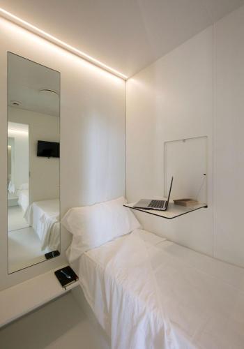 1 dormitorio con espejo y ordenador portátil en la cama en Bed & Boarding, en Nápoles