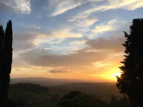 a view of a sunset from a hill at Case Nell' Aia in Poggibonsi