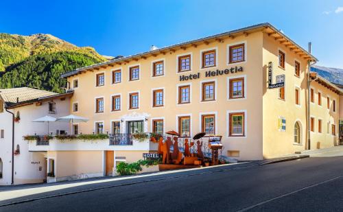 a hotel melkitzka on the side of a street at Hotel Helvetia in Müstair