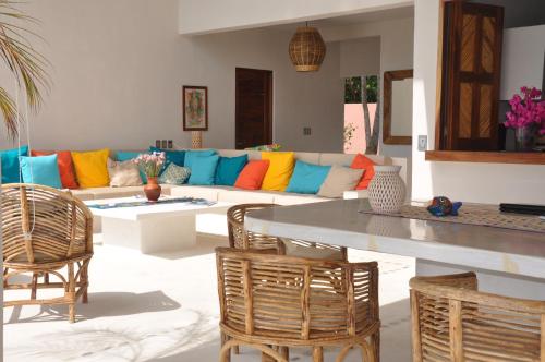 
a living room filled with furniture and a table at Casa Cometa in San Agustinillo
