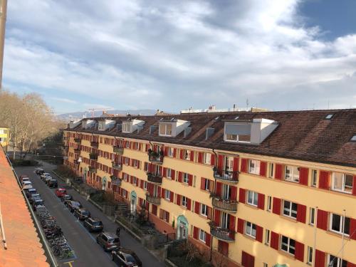 a row of buildings with cars parked on a street at Olympia Hotel Zurich in Zürich