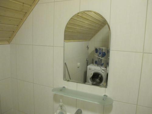 a bathroom with a mirror and a washing machine at Marina Village in Saimaa Gardens in Imatra