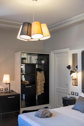 a bedroom with a bed and two lights at Hotel Grande Italia in Chioggia